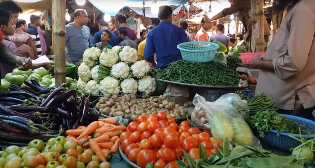 People buying vegetables in the market during the winter season